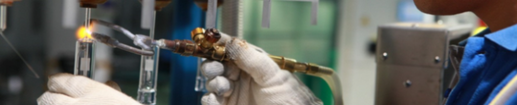 Photo of worker in a factory using an electric cutting tool